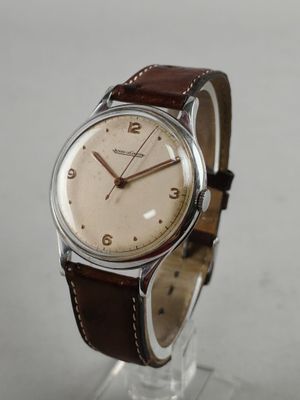 an image of a close up of a wrist watch on a stand