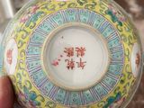 a person holding a bowl with a chinese writing on it