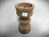 a small wooden cup with a sticker on it