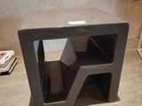 a small black table with a magazine holder on it