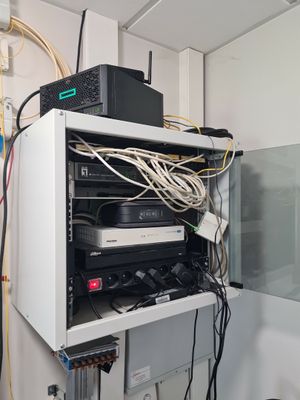 a white cabinet with a bunch of wires on top of it