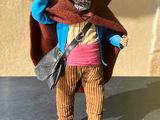 a small figurine of a man with a hat and jacket