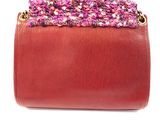 purple and red purse on a white background with a chain around it
