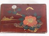 a wooden box with a painting of flowers on it