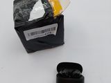 a pair of black earphones sitting on top of a white surface