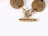 two gold tone cufflinks with the word satellite on them