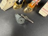 three different types of shoes and a lighter on a table