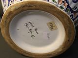 a close up of a vase with a tag on it
