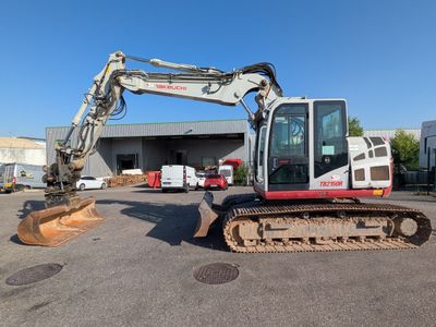 a small excavator that is parked in a parking lot