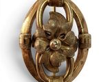 a close up of a brooch with a flower on it