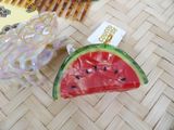a piece of watermelon sitting on a table next to a comb