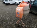 cars parked in a parking lot with a cement mixer in the foreground
