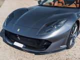 a black ferrari sports car parked on the side of the road