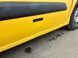 a yellow car parked on the side of the road