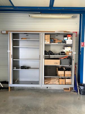 a garage with shelves and bins in it