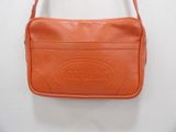a small orange purse with a logo on the front
