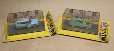 two toy cars that are in a box on a table