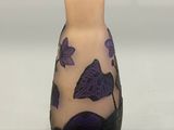 a small vase with a purple butterfly design on it