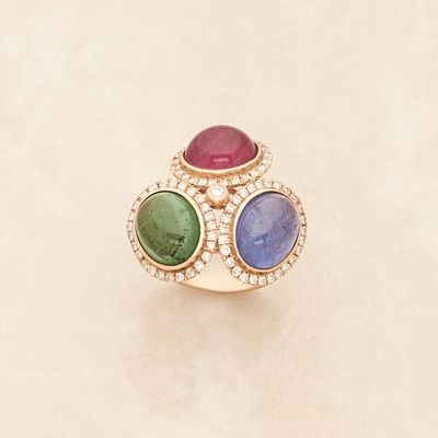 an image of a gold ring with multi colored stones and diamonds