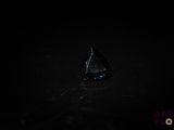 a close up of a black diamond in the dark