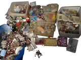 many different types of jewelry in the bins on the table