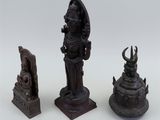 three bronze figurines of a woman and a man on a pedestal