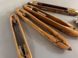 several wooden tools are lined up on a white surface