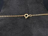 a close up of a gold chain bracelet on a mannequin mannequin
