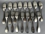 a lot of forks and spoons that are on the table