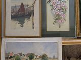 many framed pictures on the wall of a room