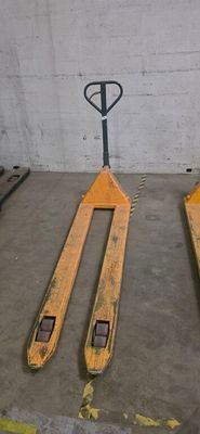 yellow forklifts sit in a warehouse with pallets in the background