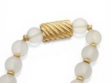 a close up of a white beaded necklace on a white background