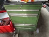a green tool cabinet with a bunch of tools in it
