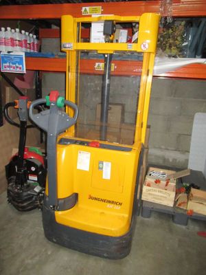 a yellow fork lift truck parked in a garage