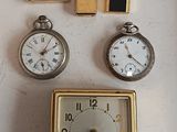 many different types of clocks on a white surface