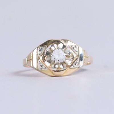 an image of a gold ring with a diamond in the center