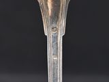 a silver spoon that is on top of a table