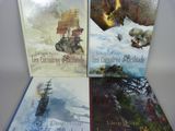 three books are sitting on a table with a white background