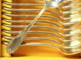 a lot of spoons and forks in a yellow box