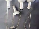 three white floor lamps on a gray background with a blue background