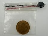 a small coin in a clear bag on a white surface