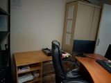 a desk with a chair and a computer on it