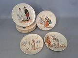 four plates with different designs of people on them sitting on a table