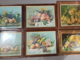 quatre tableaux représentant des fruits, encadrés et accrochés au mur d'une pièce