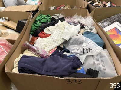 a cardboard box filled with clothes and other items