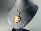 a close up of a necklace on a mannequin on a table