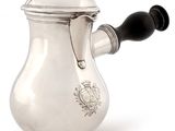 a silver coffee pot with a black handle on a white background