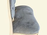 an image of a chair with a blue upholstered cushion on it