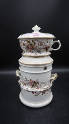 a stack of three white dishes with flowers on them