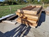several pieces of wood are stacked on top of each other in a yard